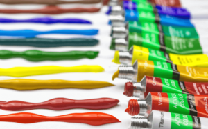 Capa do artigo teoria das cores mostrando bisnagas de tinta de várias cores.